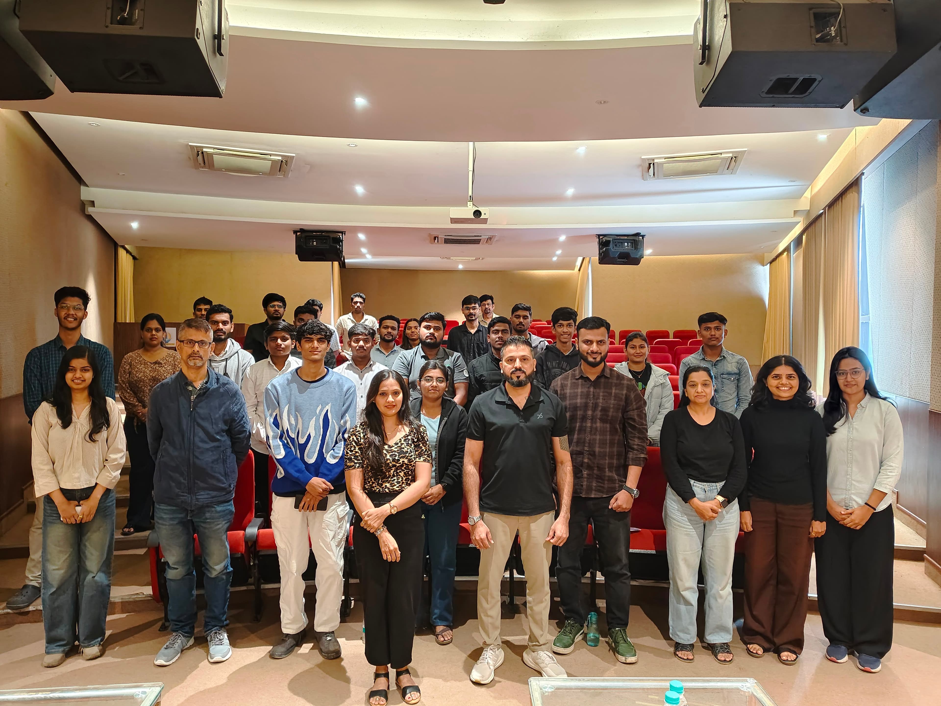 Lakeer Kukadia with students and faculty in a full university auditorium
